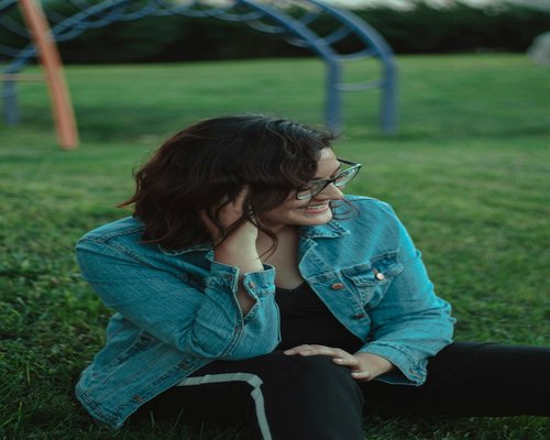 Person resting eyes while sitting in a calm park